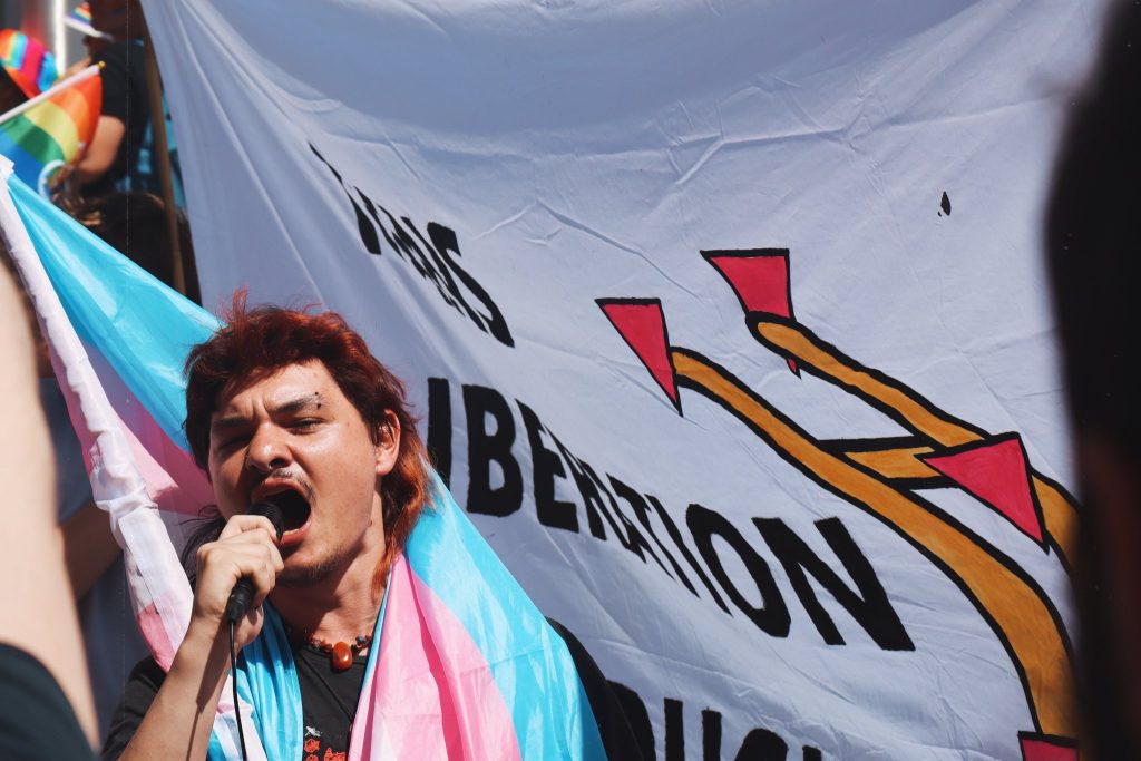 A CYM activist giving a speech via microphone at alternative pride