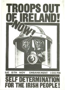 A picture of a person wearing a gas mask and riot mask, with the eye glass depicting two union flags. The text of the poster reads: "Troops out of Ireland now! Saturday 15th November, Embankment, 1 PM. Self determination for the Irish people!"